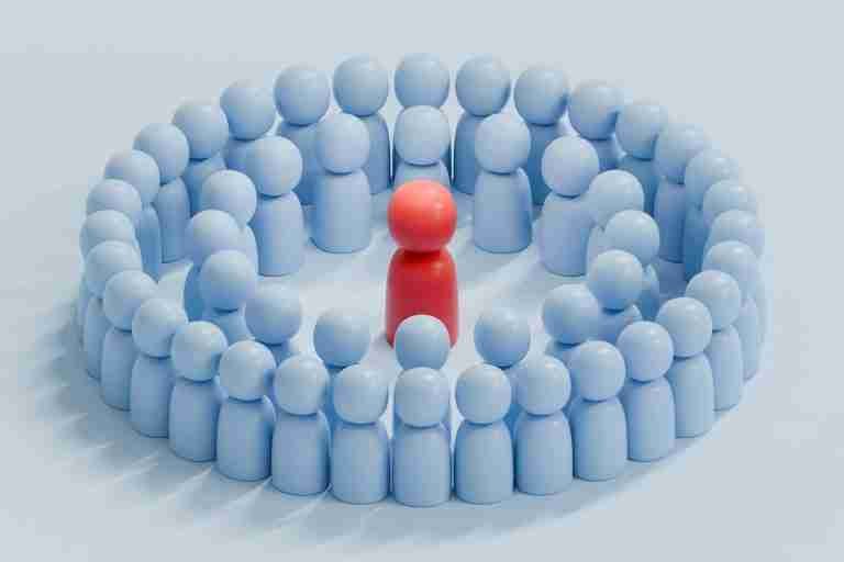 Red humanoid figure at the center of a circular ring of blue humanoid shapes